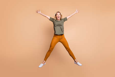 Full length photo of crazy funky lady jumping high making star shape figure spending best free time...