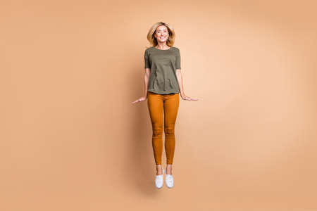 Full length photo of crazy lady jumping high excited summer mood modern look shy person wear green...