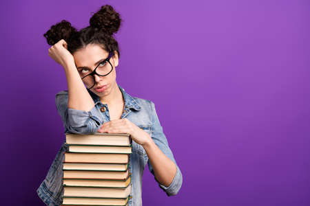 Photo of pretty student lady leaning on many books tired of boring lesson want go home wear specs...
