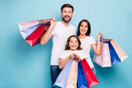 Portrait of excited positive cheerful three people mommy daddy schoolkid with brown hair shop center...
