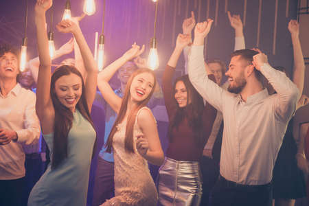 Portrair of positive cheerful corporate company mates have noel party weekend celebration go nightclub dance on friday nights feel wild wear formalwear dress skirt clothing in discothequeの写真素材