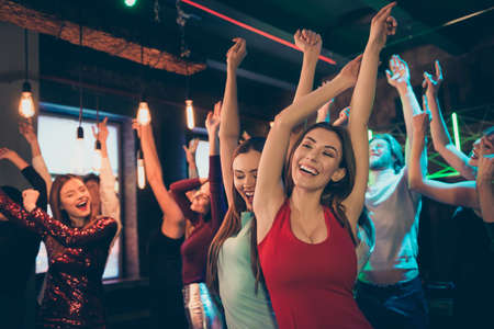 Portrait of cheerful positive girlfriends people buddies want party in night celebrate event holidays dance feel rejoice wear elegant formalwear dress raise hands scream in discothequeの写真素材