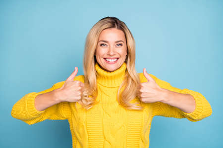 Photo of amazing pretty blond lady raising thumbs up expressing positive agree attitude new product...