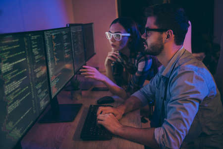 Profile photo of it specialist two guy lady business people sit night chairs coworking watch monitors correct errors bugs writing interface front-end code office indoorsの写真素材