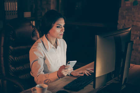 Profile side view portrait of her she nice attractive lovely chic stylish classy experienced skilled businesslady expert specialist creative designer working late at night dark work place stationの写真素材