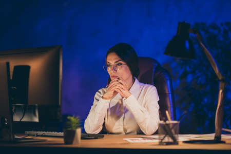 Close-up portrait of nice attractive smart clever lady top executive manager financier department ceo boss chief hardworking deadline annual report at night dark work place stationの写真素材