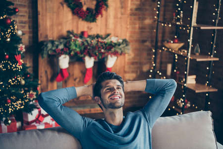Top above high angle photo of relaxing guy sit couch dream christmas party with girlfriend enjoy festive x-mas atmosphere in house with noel decoration lights mistletoe wreathの写真素材