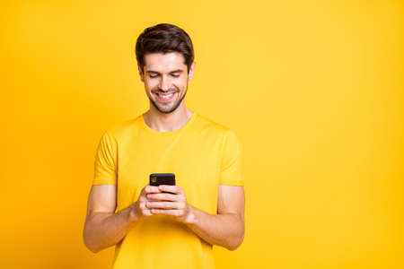Photo of amazing handsome guy holding telephone hands chatting with friends discussing future chill...