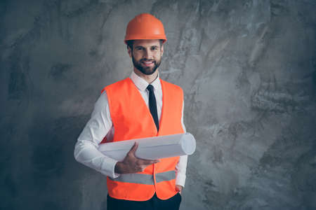 Portrait of positive professional builder architecture holding his plan for constructing building...