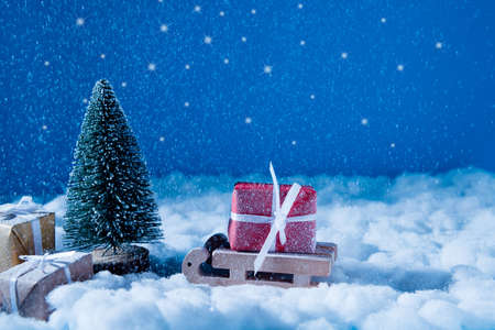 Photo of small wooden toy sledge, coming to santa claus place workshop in iceland loaded big red...