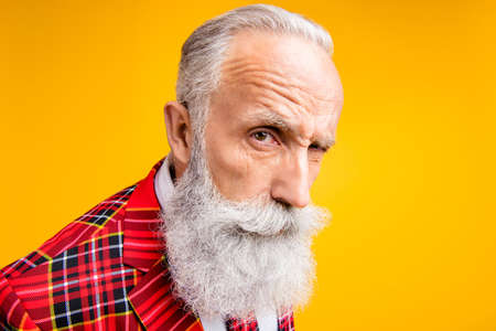 I think you are liar. Closeup photo of cool grandpa guy stylish long beard have doubts looking suspicious wear tartan blazer outfit isolated yellow color backgroundの写真素材