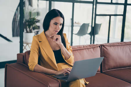 Portrait of her she nice attractive charming lovely pretty winsome trendy gorgeous focused lady launching rent real start-up in modern style interior glass room flat house apartmentの写真素材