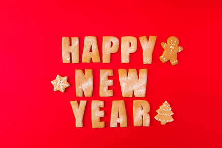 High angle view photo of three baked newyear congrats words with decorative elements figures sweet yummy x-mas composition isolated on bright red backgroundの写真素材