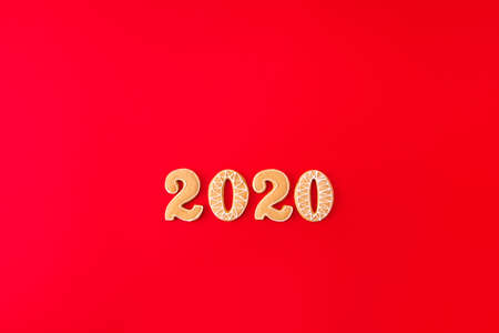Top above high angle view photo of tasty pastry ginger bread cookies creative x-mas composition on shape letters numbers making 2020 isolated over red shine color backgroundの写真素材