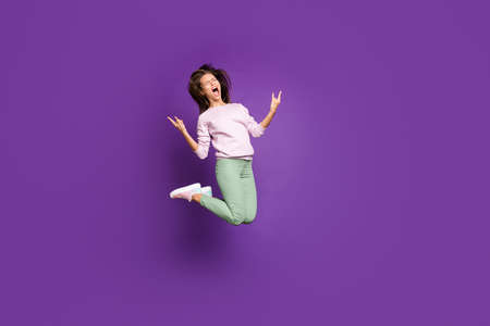 Full length body size view of her she nice attractive lovely comic childish overjoyed cheery girl jumping showing horns sign isolated on bright vivid shine vibrant purple violet lilac color backgroundの写真素材