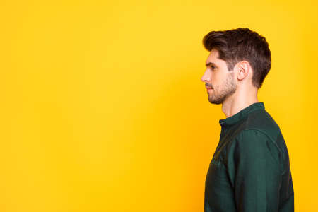 Profile side photo of serious pensive guy imagine he real boss executive in his company listen to employers ready solve work problems wear casual style outfit isolated over yellow color backgroundの写真素材