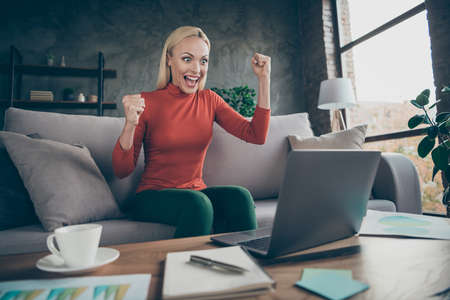 Photo of crazy blond business lady raising fists up celebrating first investment startup project...