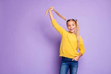 Portrait of cheerful kid enjoy fun weekends hold pigtails wear casual style clothing isolated over...