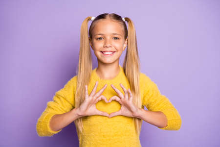 Photo of cheerful positive girl smiling toothily stylish trendy showing heart shape sign with fingers isolated pastel violet color backgroundの写真素材