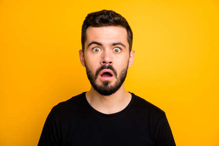 Close up photo of astonished guy hear incredible news open mouth cant believe black friday information wear good looking outfit isolated over yellow color backgroundの写真素材