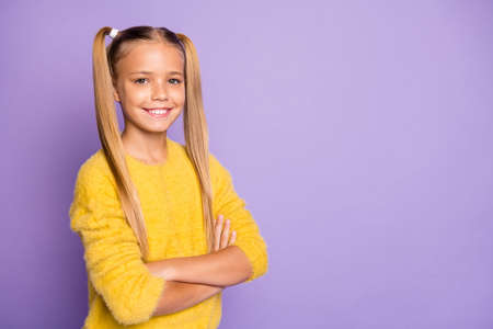 Turned photo of positive cool glad child future professional cross her hands good look wear yellow...