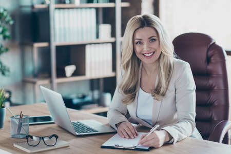 Photo of amazing blond business lady notebook table signing contract important partner prepared...