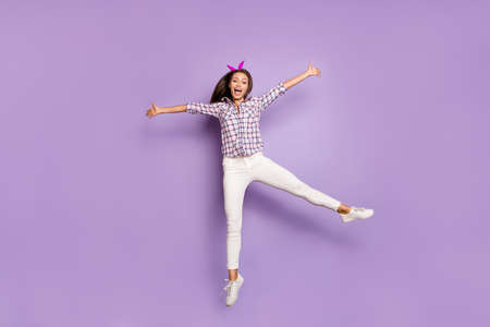 Full length body size view of her she nice attractive lovely cheerful cheery girl jumping having fun time celebrating holiday vacation weekend isolated over violet purple lilac pastel color backgroundの写真素材
