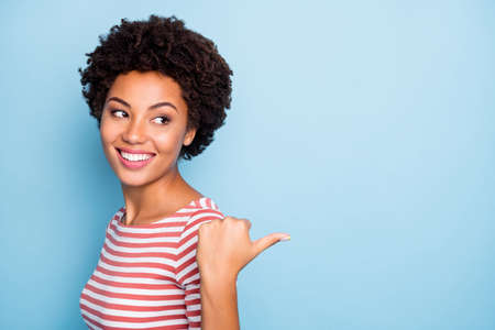 Closeup photo of pretty dark skin sales manager lady indicating finger empty space advising buyers...