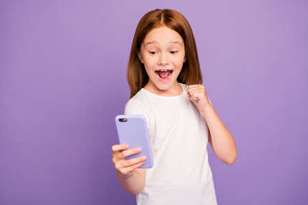 Photo of funny small excited foxy lady holding telephone hands checking blog excited with many new...