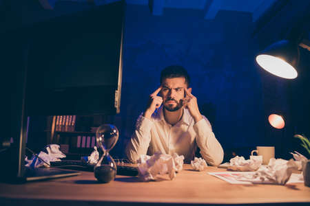 Photo of pensive overwhelmed business man doing overtime work displeased with result of his...