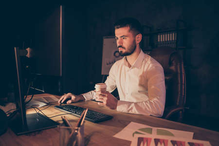 Photo of pensive thoughtful entrepreneur looking pensively into screen in search of new information...