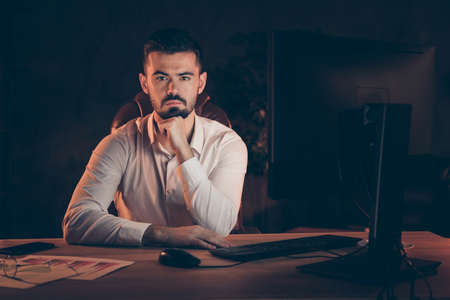 Photo of serious confident man listening to empoloyee willing to get job at his company bearded with...