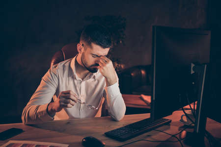 Photo of troubled worried man with head aching living through difficulties at work and having to...