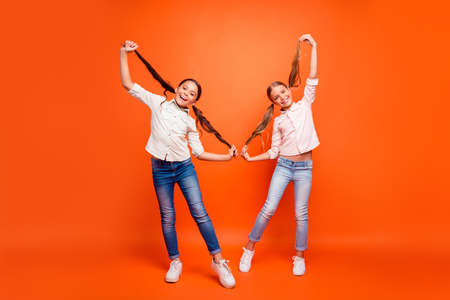 Full size photo of funky funny two children girl relax free time fall holidays hold ponytails enjoy...