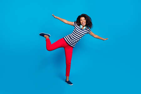 Full length photo of positive funky funny afro american girl have rest headset to listen music hold...