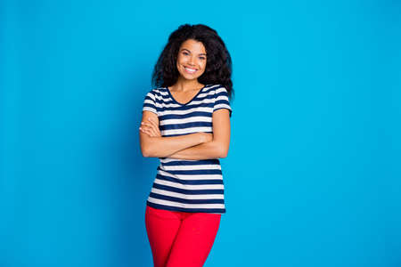 Photo of toothy beaming cheerful positive cute nice girlfriend standing confidently with hands folded smiling toothily as a reliable person isolated bright blue color backgroundの写真素材