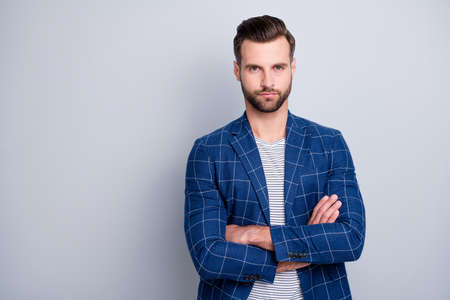 Photo of serious confident smart man with hands folded bristle staring at you during job interview with no emotions isolated grey color backgroundの写真素材