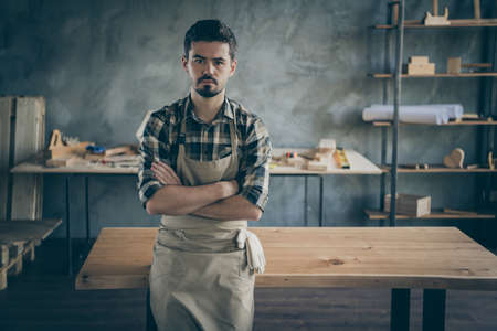 One of my best works. Photo of handsome confident guy master leaning handmade slab table arms...
