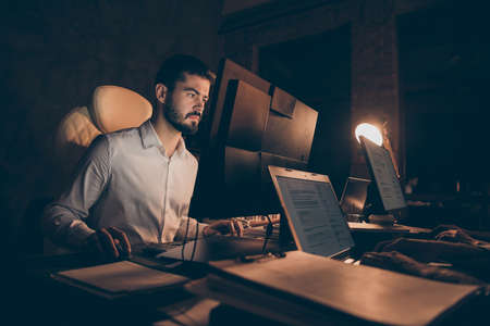 Portrait of his he nice attractive focused skilled professional guy ceo boss chief employer working at night difficult task solving work place station indoorsの写真素材