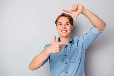 Portrait of positive cheerful guy make photo with his hands index thumb, fingers focus wear stylish...
