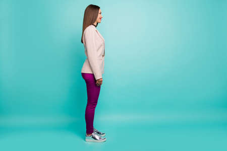 Full length body size profile side view of nice attractive lovely cheerful cheery content straight-haired girl isolated on bright vivid shine vibrant blue green turquoise color backgroundの写真素材