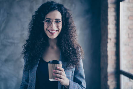 Portrait of her she nice-looking attractive cute charming lovely cheerful cheery glad content wavy-haired girl drinking espresso at modern industrial loft brick interior style roomの写真素材