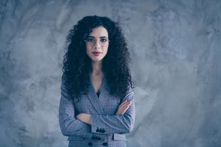 Portrait of her she nice-looking attractive charming lovely chic content calm wavy-haired girl marketer financier folded arms isolated over gray concrete wall backgroundの写真素材