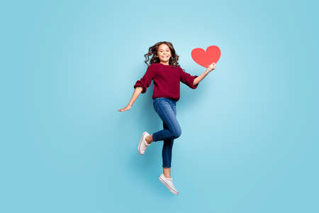 Full length body size photo of cheerful nice curly wavy girlfriend holding big red postcard smiling...
