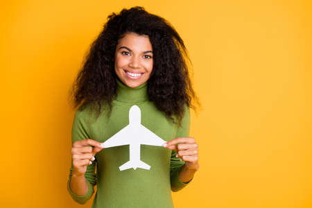Photo of cheerful positive mixed-race toothy beaming cute girlfriend demonstrating toy of air plane...