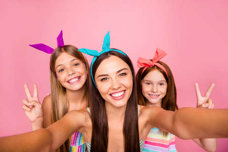 Close up photo of three people in headbands making v-signs selfie wearing dress skirt isolated over...