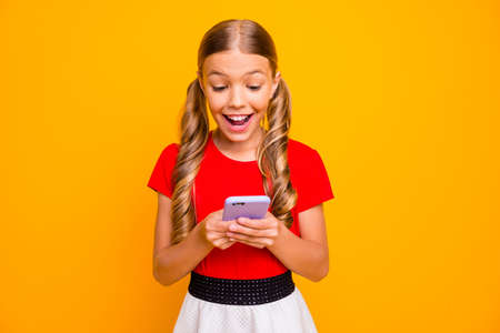 Photo of nice small lady holding telephone hands young influencer popular blog reading new positive...