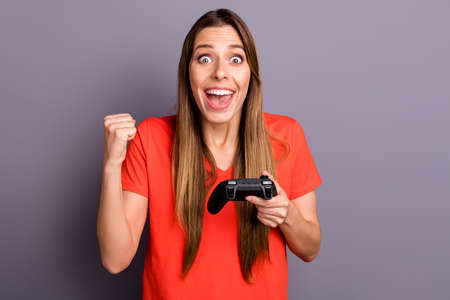 Wow omg i win. Amazed impressed girl play video game get victory scream raise fists wear stylish red...