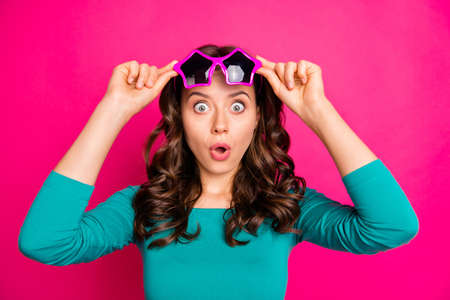 Photo of cheerful positive nice funny girlfriend expressing stunning emotions with eyes and mouth open widely lips pouted isolated fuchsia vibrant color backgroundの写真素材