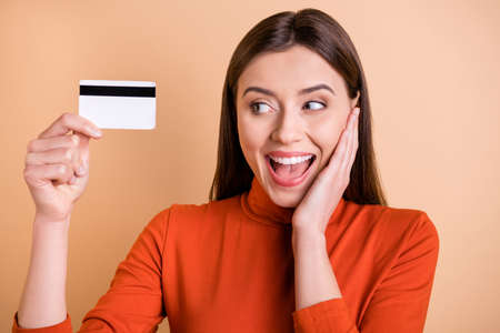 Close up photo of cheerful charming cute nice girlfriend having received her new credit card...